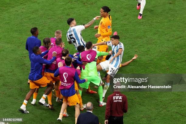 Virgil Van Dijk of Netherlands clashes with Leandro Paredes of Argentina during the FIFA World Cup Qatar 2022 quarter final match between Netherlands...