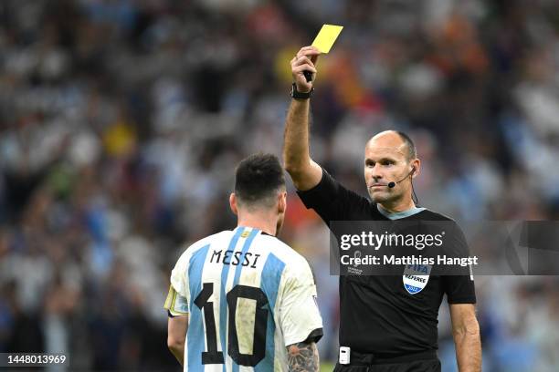 Referee Antonio Mateu shows a yellow card to Lionel Messi of Argentina during the FIFA World Cup Qatar 2022 quarter final match between Netherlands...