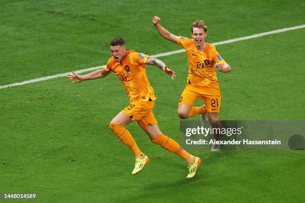 Wout Weghorst of Netherlands celebrates with teammate Frenkie de Jong after scoring the team's second goal during the FIFA World Cup Qatar 2022...