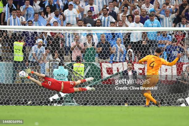 Emiliano Martinez of Argentina makes a save on the first penalty by Virgil Van Dijk of Netherlands during the FIFA World Cup Qatar 2022 quarter final...