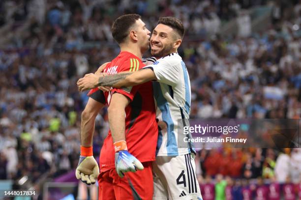 Emiliano Martinez and Gonzalo Montiel of Argentina react in the penalty shoot out during the FIFA World Cup Qatar 2022 quarter final match between...