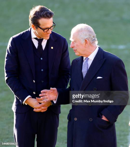 King Charles III talks with co-owner of Wrexham AFC Ryan Reynolds as he visits Wrexham Association Football Club on December 9, 2022 in Wrexham,...