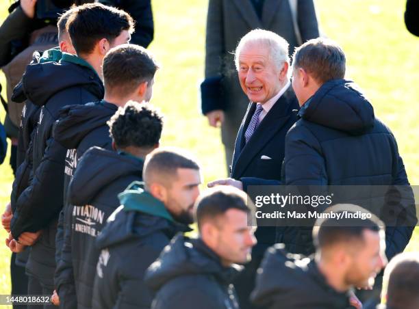 King Charles III talks with Wrexham AFC players as he visits Wrexham Association Football Club on December 9, 2022 in Wrexham, Wales. Formed in 1864...