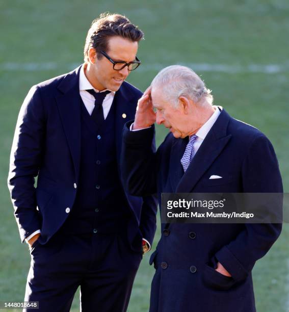 King Charles III talks with co-owner of Wrexham AFC Ryan Reynolds as he visits Wrexham Association Football Club on December 9, 2022 in Wrexham,...