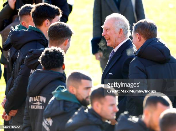 King Charles III talks with Wrexham AFC players as he visits Wrexham Association Football Club on December 9, 2022 in Wrexham, Wales. Formed in 1864...
