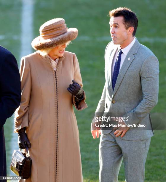 Camilla, Queen Consort talks with co-owner of Wrexham AFC Rob McElhenney as she visits Wrexham Association Football Club on December 9, 2022 in...