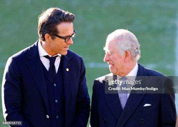 King Charles III talks with co-owner of Wrexham AFC Ryan Reynolds as he visits Wrexham Association Football Club on December 9, 2022 in Wrexham,...