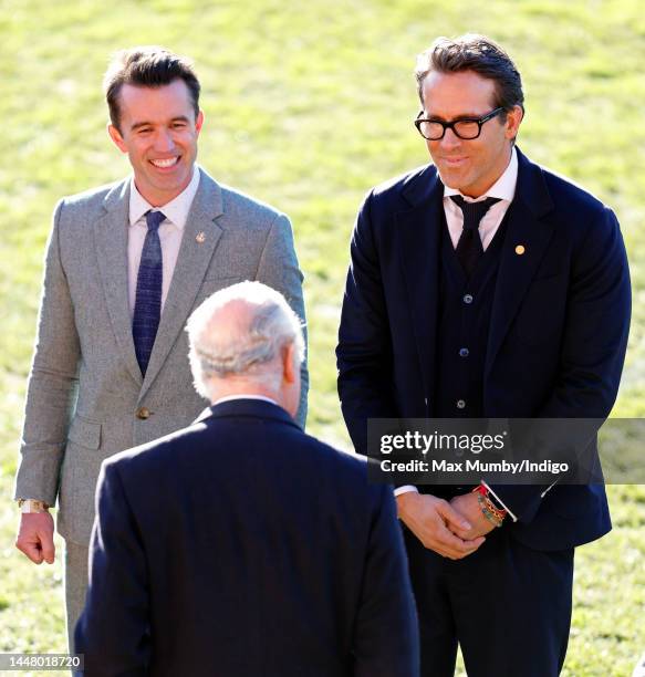 King Charles III talks with co-owners of Wrexham AFC Rob McElhenney and Ryan Reynolds as he visits Wrexham Association Football Club on December 9,...