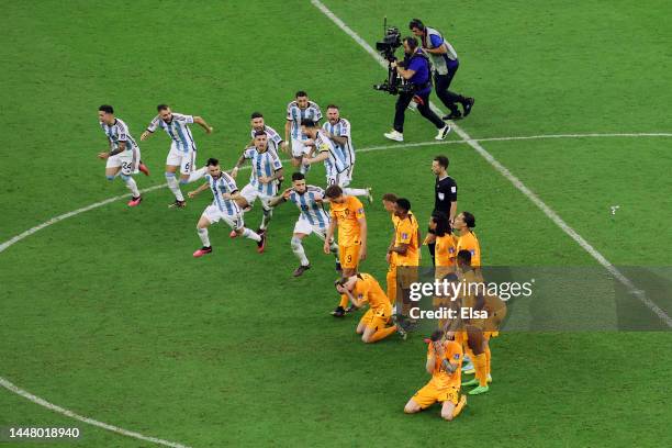 Argentina players including Nicolas Otamendi celebrate after their win in the penalty shootout as Netherlands players react during the FIFA World Cup...