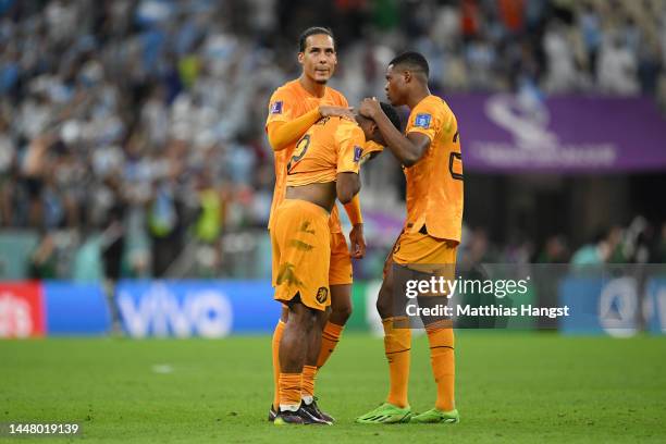 Virgil Van Dijk of Netherlands reacts with Jurrien Timber and Denzel Dumfries after the loss in the penalty shootout during the FIFA World Cup Qatar...