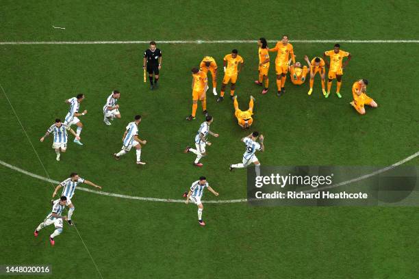 Argentina players celebrate after their win in the penalty shootout as Netherlands players react during the FIFA World Cup Qatar 2022 quarter final...