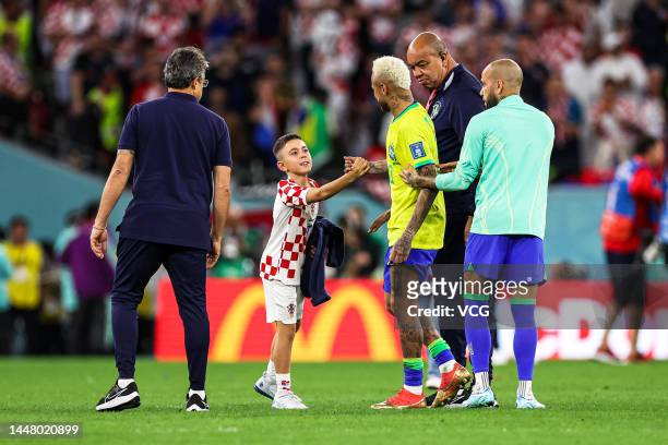 Neymar of Brazil is consoled by a young Croatia supporter after the FIFA World Cup Qatar 2022 quarter final match between Croatia and Brazil at...