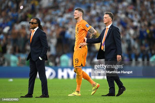 Louis van Gaal, Head Coach of Netherlands, assistant coach Edgar Davids and Wout Weghorst stand dejected after the loss in the penalty shootout in...