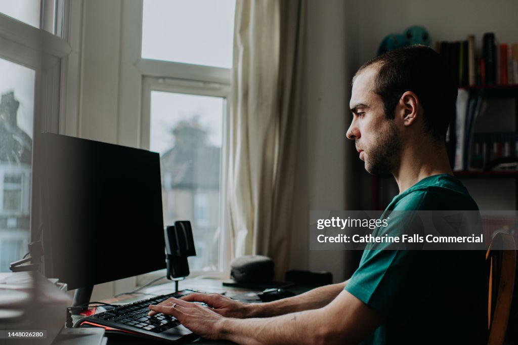 A Man Works From Home On A Desktop Pc High-Res Stock Photo - Getty Images
