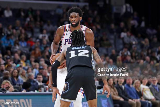 Joel Embiid of the Philadelphia 76ers handles the ball against Ja Morant of the Memphis Grizzlies during the game at FedExForum on December 02, 2022...