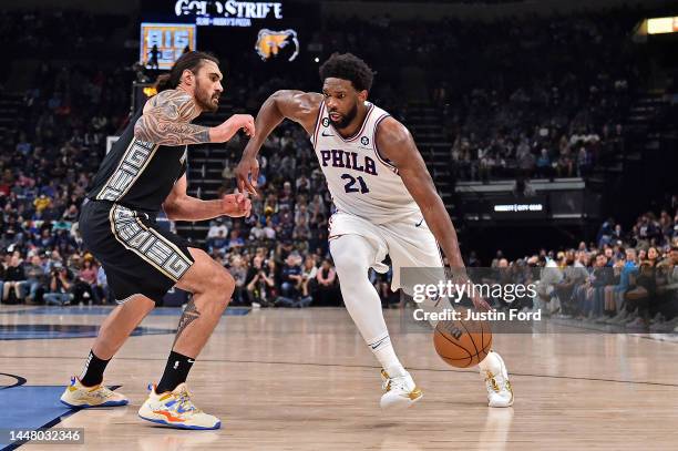 Joel Embiid of the Philadelphia 76ers handles the ball against Steven Adams of the Memphis Grizzlies during the game at FedExForum on December 02,...