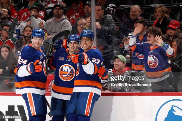 Scott Mayfield, Alexander Romanov and Anders Lee of the New York Islanders celebrate Lee's first period goal against the New Jersey Devils at the...