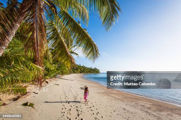 woman walking on exotic beach with palm trees, fiji - pacific islands stock pictures, royalty-free photos & images