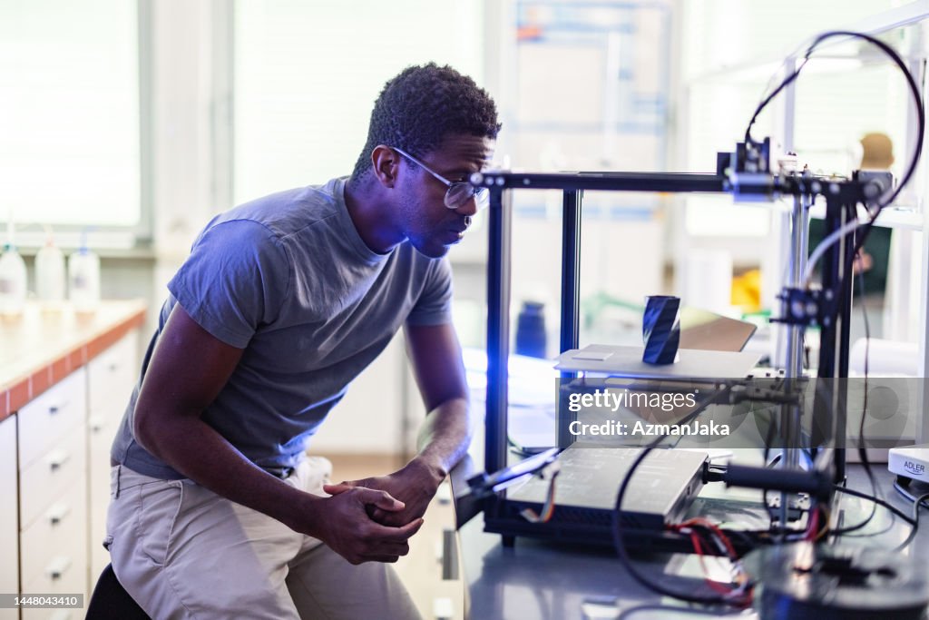 Male Engineer Looking At 3D Printer