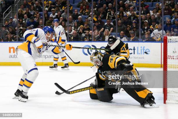 Jeff Skinner of the Buffalo Sabres scores a goal through Tristan Jarry and Jan Rutta of the Pittsburgh Penguins during the second period of an NHL...