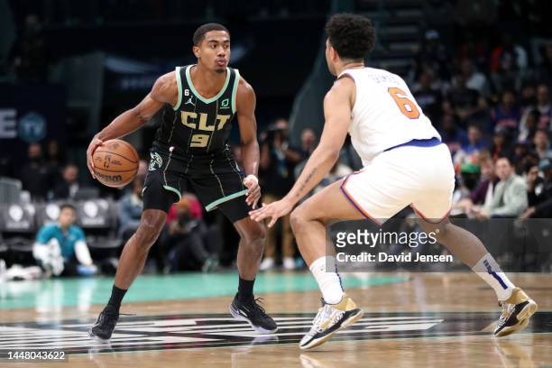 Theo Maledon of the Charlotte Hornets is guarded by Quentin Grimes of the New York Knicks during the first half of the game at Spectrum Center on...