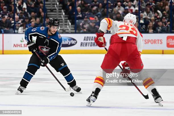 Johnny Gaudreau of the Columbus Blue Jackets controls the puck against Trevor Lewis of the Calgary Flames during the second period of the game at...