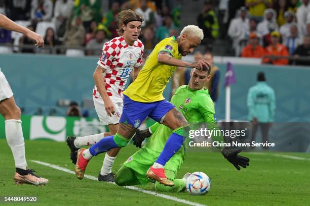 Neymar of Brazil scores his team's first goal past goalkeeper Dominik Livakovic of Croatia during the FIFA World Cup Qatar 2022 quarter final match...