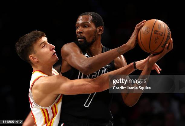 Kevin Durant of the Brooklyn Nets controls the ball as Bogdan Bogdanovic of the Atlanta Hawks defends during the 2nd half of the game at Barclays...