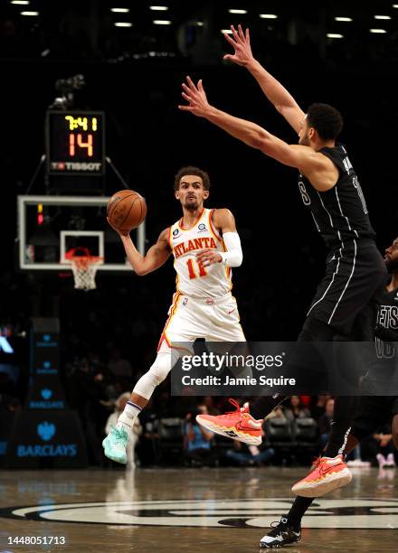 Trae Young of the Atlanta Hawks looks to pass as Ben Simmons of the Brooklyn Nets defends during the 2nd half of the game at Barclays Center on...