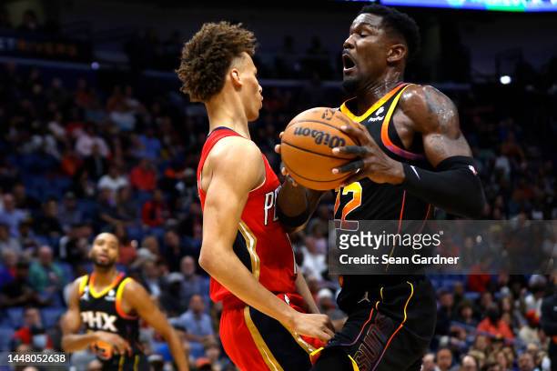 Dyson Daniels of the New Orleans Pelicans draws the charging foul from Deandre Ayton of the Phoenix Suns during the first qurarter of an NBA game at...