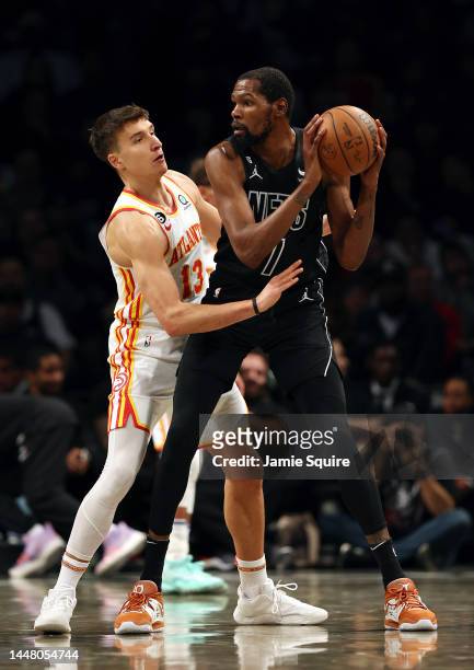 Kevin Durant of the Brooklyn Nets controls the ball as Bogdan Bogdanovic of the Atlanta Hawks defends during the 2nd half of the game at Barclays...