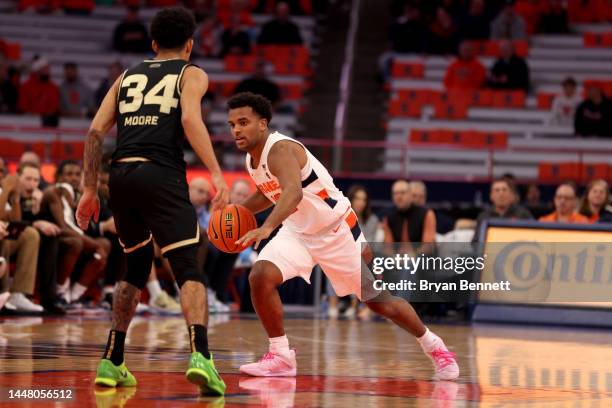 Anthony Clayton of the Syracuse Orange drives to the basket as Jalen Moore of the Oakland Golden Grizzlies guards him during the second half at the...