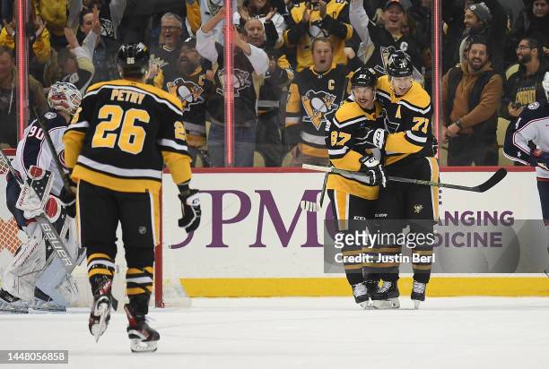 Sidney Crosby of the Pittsburgh Penguins celebrates with Evgeni Malkin after scoring his second goal in the second period during the game against the...