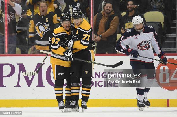 Sidney Crosby of the Pittsburgh Penguins celebrates with Evgeni Malkin after scoring his second goal in the second period during the game against the...