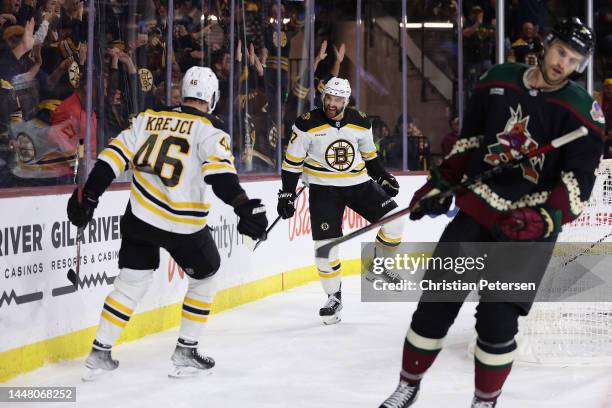 Nick Foligno of the Boston Bruins celebrates with David Krejci after scoring a power-play goal against the Arizona Coyotes during the third period of...