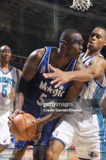 Horace Grant of the Orlando Magic looks to pass against the Charlotte Hornets during a game at the Charlotte Coliseum in Charlotte, North Carolina....