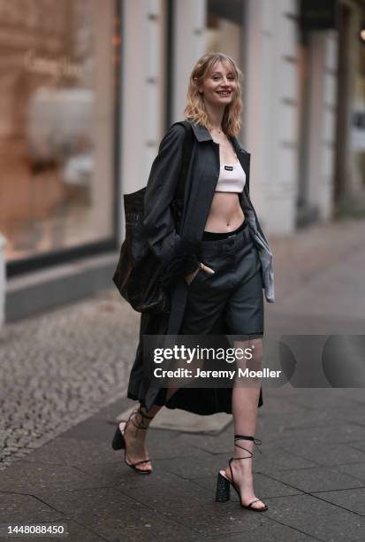 Trixi Giese seen wearing a total Miu Miu look with lace-up heels by Miu Miu, a white croptop and grey shorts by Miu Miu, a Miu Miu grey cardigan and...