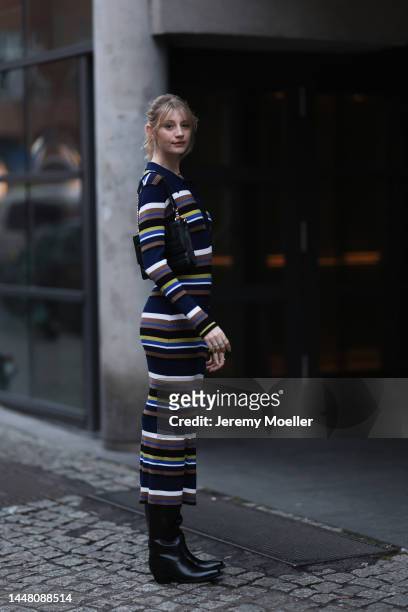 Trixi Giese seen wearing a striped long dress by Munthe, black boots by Iceberg and a black bag by Jimmy Choo on December 06, 2022 in Berlin, Germany.