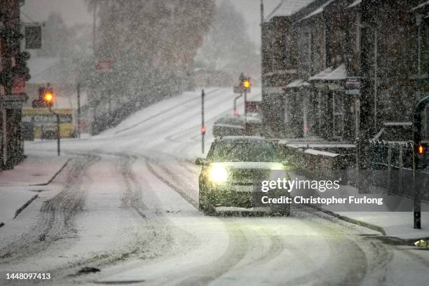 Cars make their way through a snow flurry, the first significant snow fall in Cheshire this Winter on December 10, 2022 in Northwich, United Kingdom....