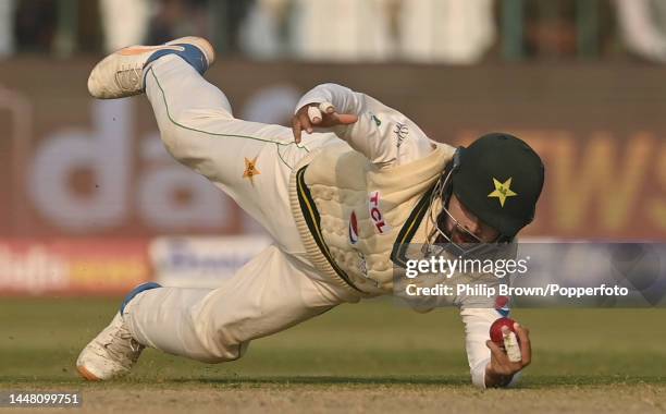 Abdullah Shafique of Pakistan catches Joe Root of England during the second day of the second Test between Pakistan and England at Multan Cricket...