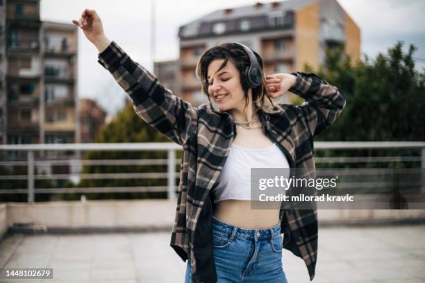 young girl is dancing on the rooftop - crop top stock pictures, royalty-free photos & images