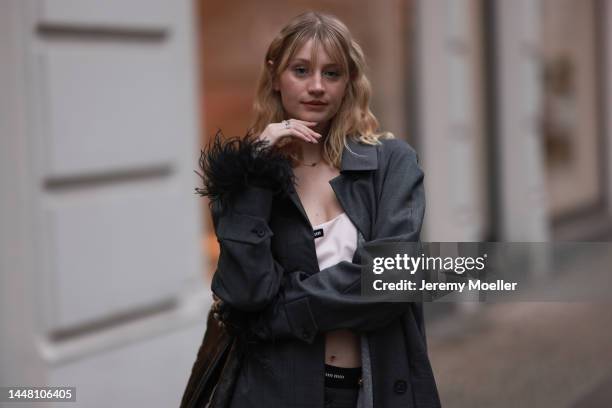 Trixi Giese seen wearing a total Miu Miu look with lace-up heels by Miu Miu, a white croptop and grey shorts by Miu Miu, a Miu Miu grey cardigan and...