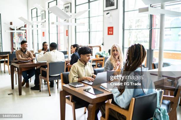 people studying in a library - community college campus stock pictures, royalty-free photos & images