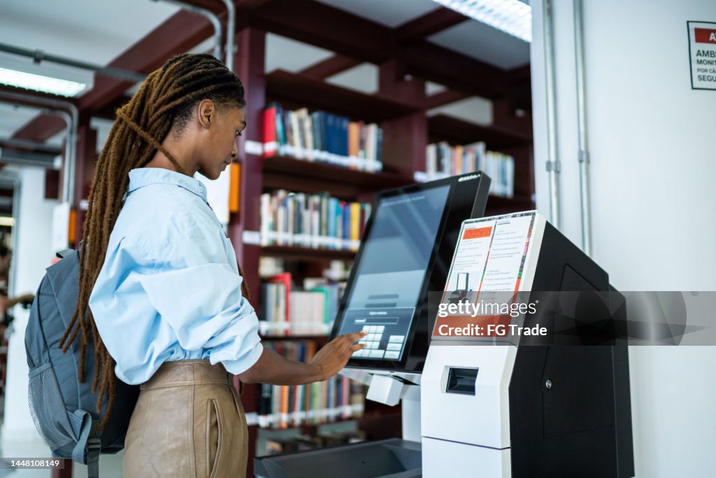 Students Library Id Student Searching For A Book In The Library System High-Res Stock Photo ...