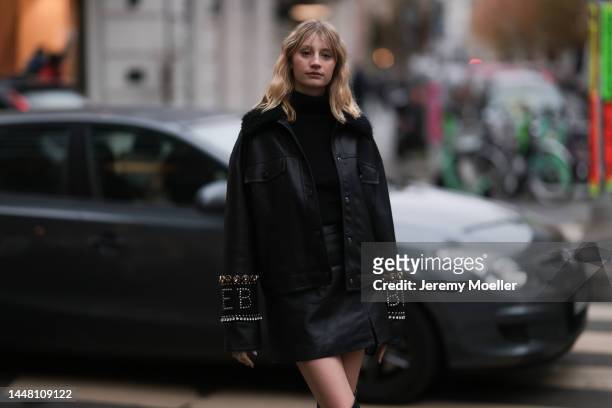Trixi Giese seen wearing an oversized black leather jacket by Iceberg, glasses by Gentle Monster, high black leather boots by Iceberg, a black...