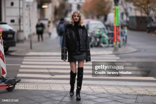 Trixi Giese seen wearing an oversized black leather jacket by Iceberg, glasses by Gentle Monster, high black leather boots by Iceberg, a black...
