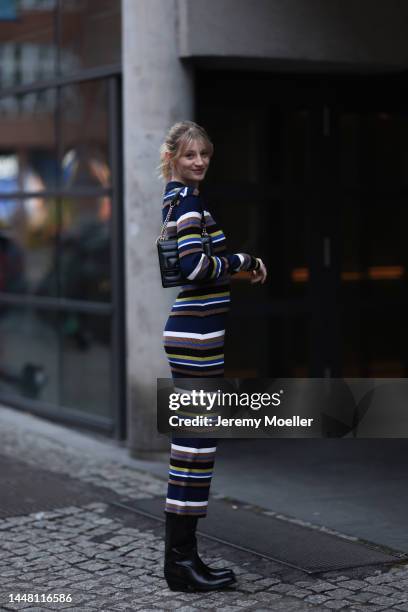 Trixi Giese seen wearing a striped long dress by Munthe, black boots by Iceberg and a black bag by Jimmy Choo on December 06, 2022 in Berlin, Germany.