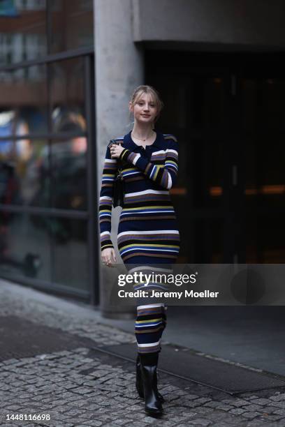 Trixi Giese seen wearing a striped long dress by Munthe, black boots by Iceberg and a black bag by Jimmy Choo on December 06, 2022 in Berlin, Germany.