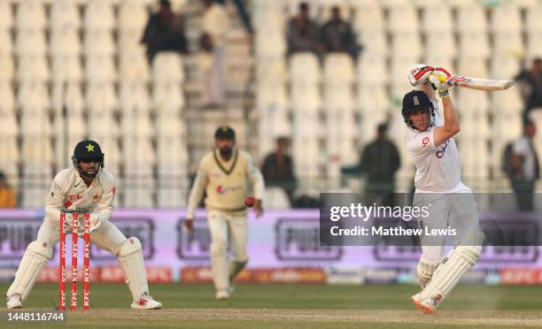 Harry Brook of England drives the ball towards the boundary, as Mohammad Rizwan of Pakistan watches on during day two of the Second Test Match...