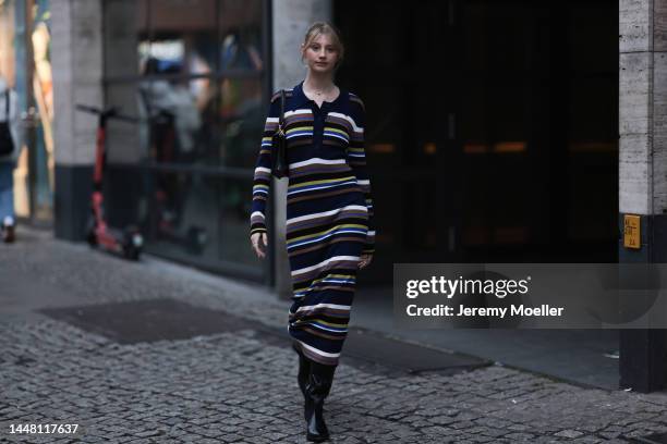 Trixi Giese seen wearing a striped long dress by Munthe, black boots by Iceberg and a black bag by Jimmy Choo on December 06, 2022 in Berlin, Germany.